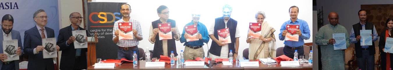 Participants holding copies of a report at a launch event